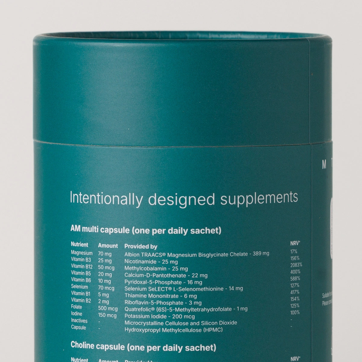 A teal cylindrical supplement canister with white text reading 'Intentionally designed supplements' and a detailed supplement facts table below, photographed against a light neutral background.